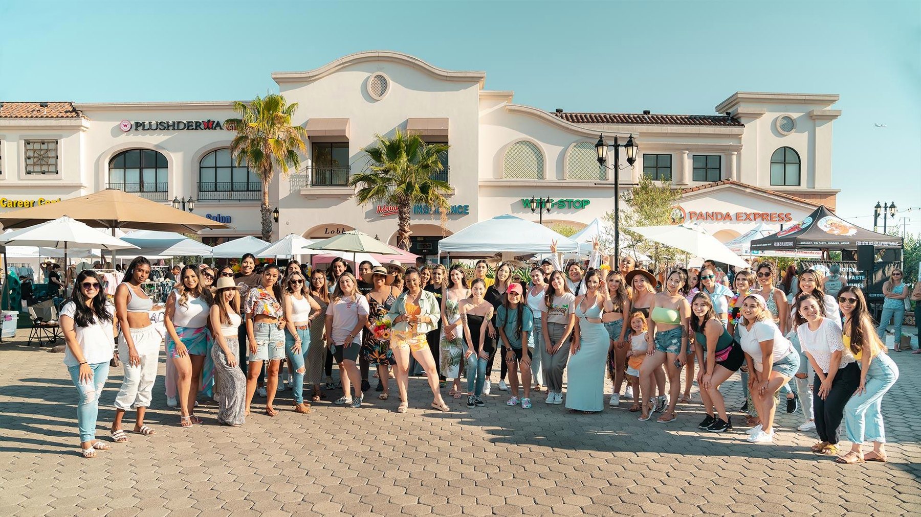Shoppers gathered outside the storefronts at Plaza La Alameda